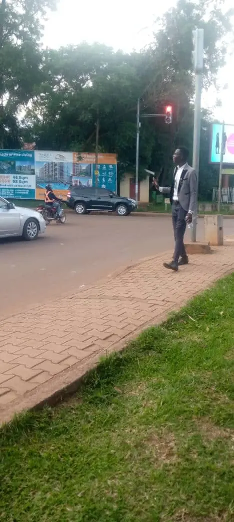 Evangelist in a suit handing out gospel tracts at a city road junction